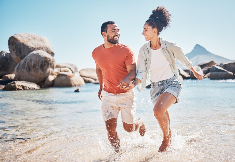 Black,Couple,,Beach,And,Running,While,Holding,Hands,On,Vacation