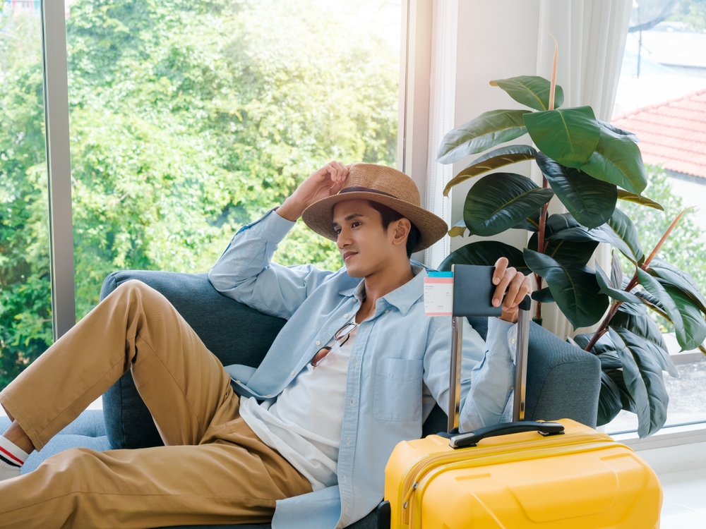 A,Man,With,Yellow,Luggage.,Handsome,Asian,Male,In,Denim