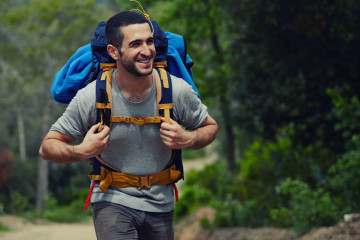 Portrait,Of,A,Young,Smiling,Wanderer,Man,With,Backpack,Goes