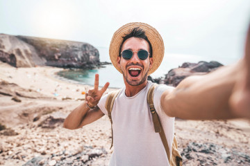 Young,Man,With,Backpack,Taking,Selfie,Portrait,On,A,Mountain