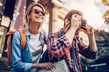 Couple,Of,Tourists,Is,Exploring,New,City,Together.,Smiling,And