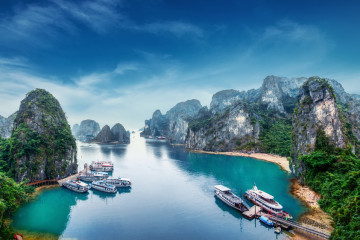 Tourist,Junks,Floating,Among,Limestone,Rocks,At,Ha,Long,Bay,
