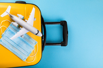 Yellow,Suitcase,With,Traveler,Accessories,On,A,Blue,Background.travel,Concept
