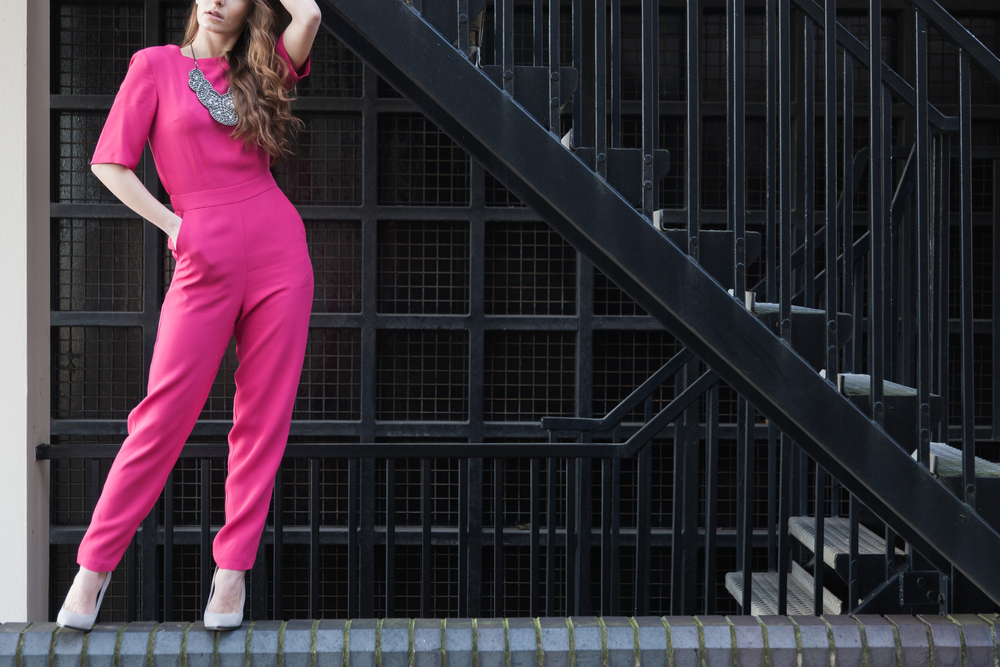 Young,Girl,Model,Posing,Wearing,A,Pink,Jumpsuit,With,A