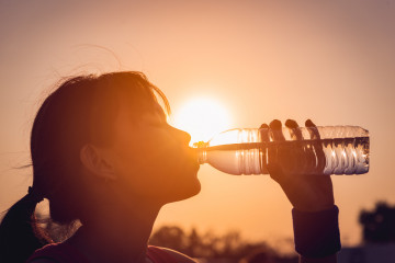 Female,Drinking,A,Bottle,Of,Water,Silhouette.