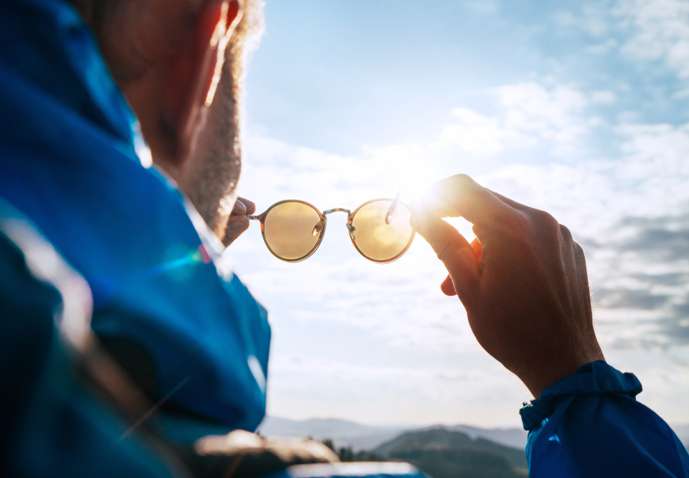 Backpacker,Man,Looking,At,Bright,Sun,Through,Polarized,Sunglasses,Enjoying