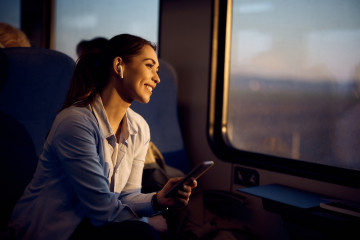 Happy,Passenger,Enjoying,In,View,Through,The,Window,At,Sunset