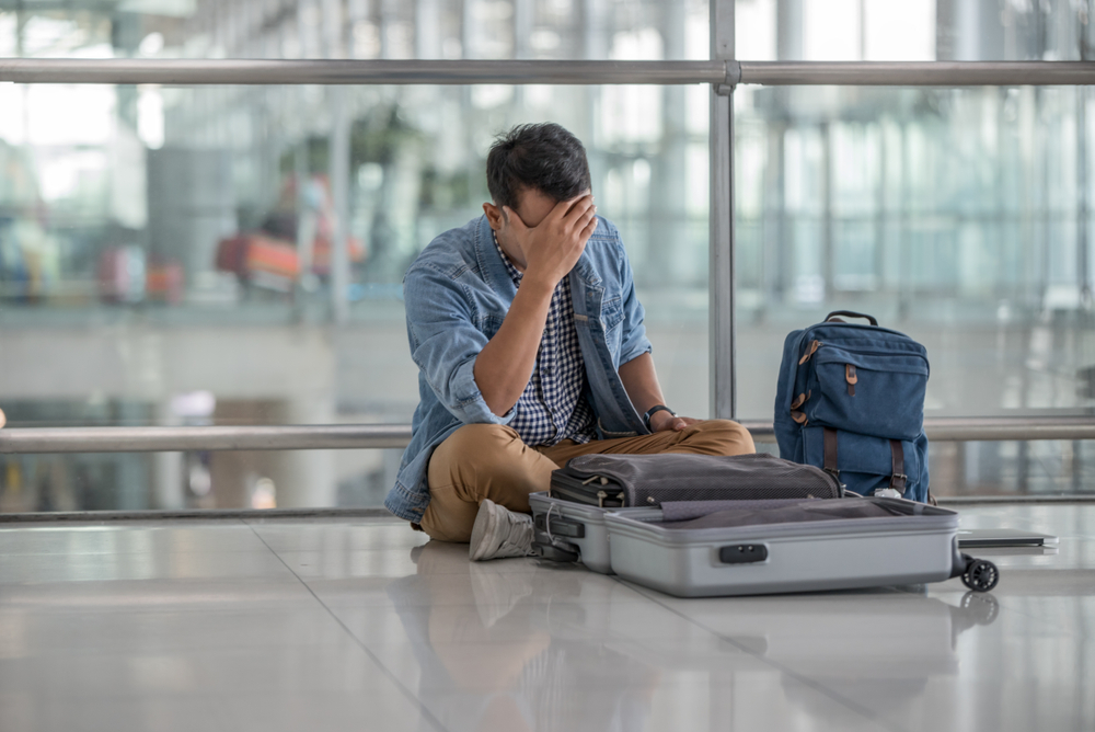 Young,Traveler,Man,With,Casual,Clothes,Sitting,On,The,Floor