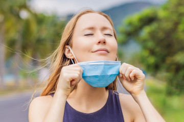 Quarantine,Is,Over,Concept.,Woman,Taking,Off,Mask,Outdoor.,We