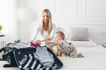 Travelling,With,Kids.,Happy,Mother,With,Her,Child,Packing,Clothes
