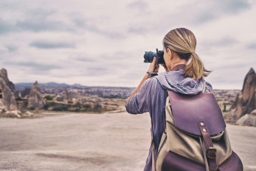 Traveling,And,Photography.,Young,Woman,With,Camera,And,Backpack,Taking