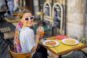 Woman,Eating,Italian,Pasta,And,Drinking,Wine,At,Restaurant,On