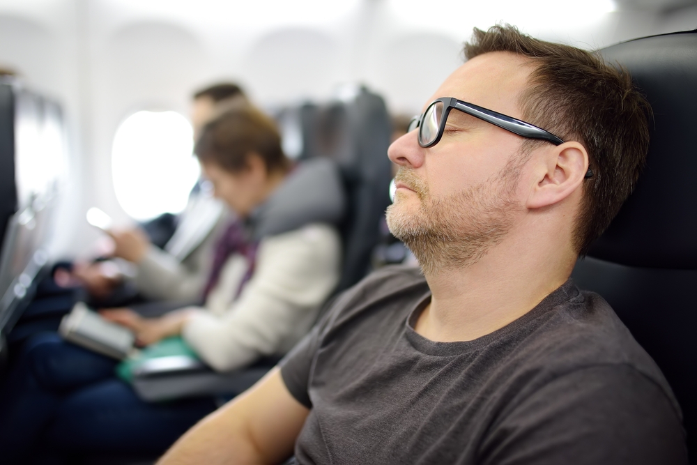 Mature,Man,Sleeping,While,Traveling,By,An,Airplane.,Tired,Passenger