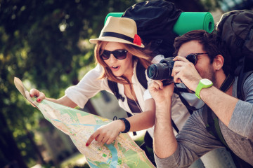 Two,Young,Tourists,With,Backpacks,Sightseeing,City