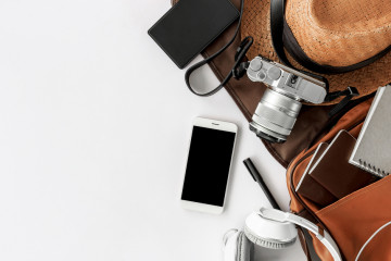 Top,View,Of,Essential,Modern.,Travel,Accessories,On,White,Wooden