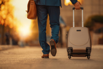 Business,Traveler,Pulling,Suitcase,On,Airport.business,Travel.