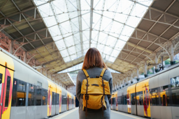 Winter,Travel,,Woman,With,Backpack,Waiting,For,Her,Train,On