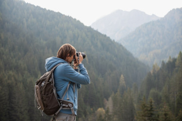 Man,Photographer,Taking,Photographs,With,Digital,Camera,In,A,Mountains.