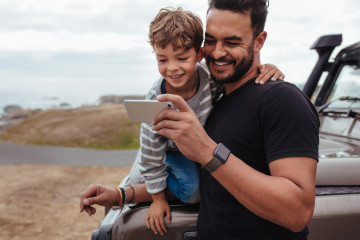 Father,With,Little,Boy,Using,Smart,Phone,Together,During,Road