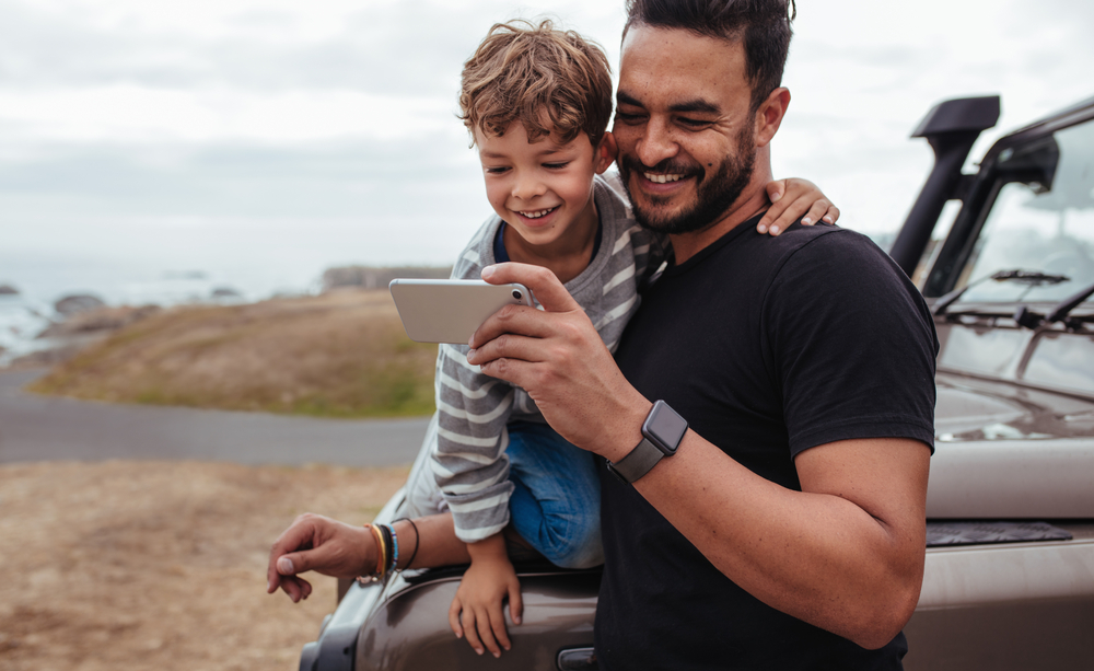 Father,With,Little,Boy,Using,Smart,Phone,Together,During,Road