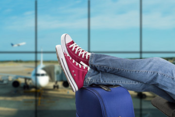 Young,Man,Waiting,For,The,Plane,At,An,Airport