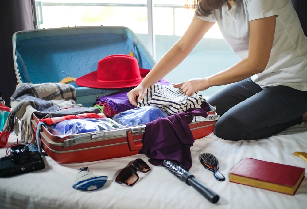 Woman,Packing,Suitcase,On,Bed,For,A,New,Journey,Packing