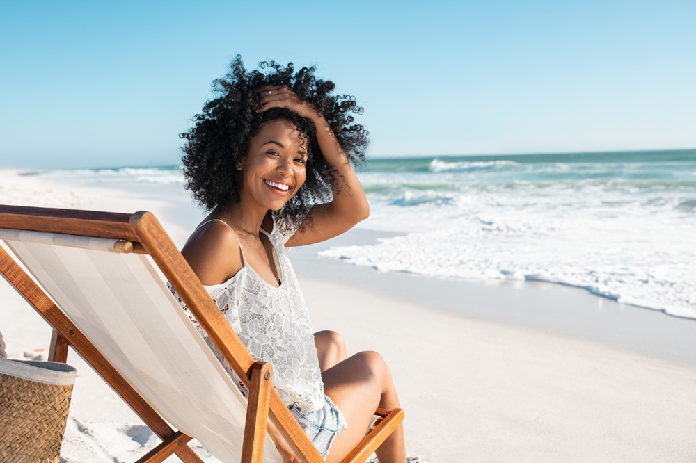 Portrait,Of,Happy,African,American,Woman,Sunbathing,On,Wooden,Deck