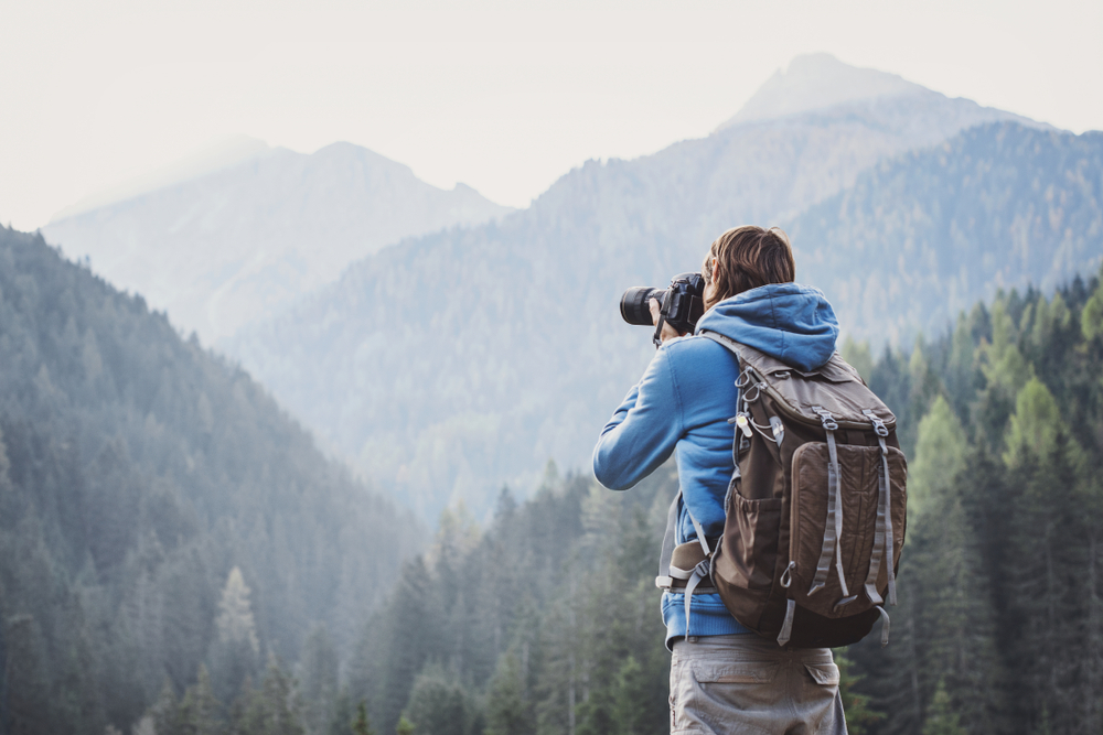 Young,Cheerful,Man,Photographer,Taking,Photographs,With,Digital,Camera,In