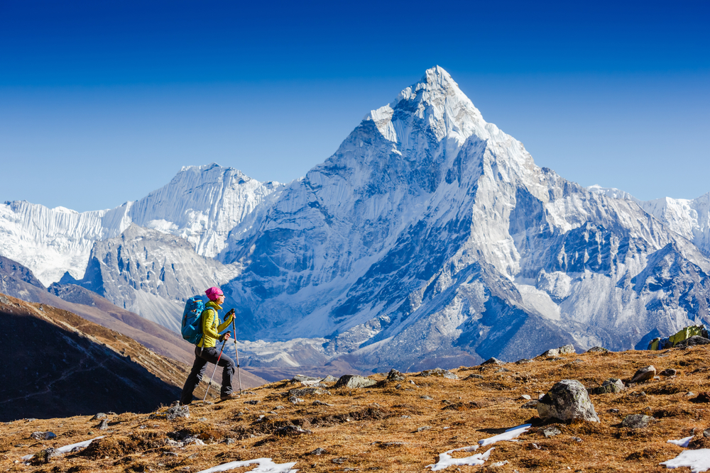 Woman,Traveler,Hiking,In,Himalaya,Mountains,With,Mount,Everest,,Earth's