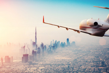 Private,Jet,Plane,Flying,Above,Dubai,City,In,Beautiful,Sunset