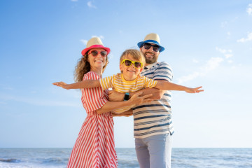 Happy,Family,Having,Fun,On,The,Beach.,Mother,And,Father