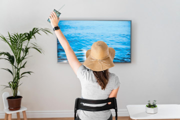Woman,At,Home,Pretending,To,Be,On,The,Beach.,Tv