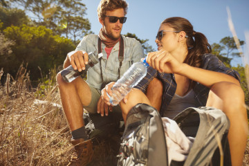 Young,Couple,Taking,A,Break,On,A,Hike.,Caucasian,Man