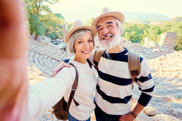 Tourism,And,Technology.,Traveling,Senior,Couple,Taking,Selfie,Together,Against