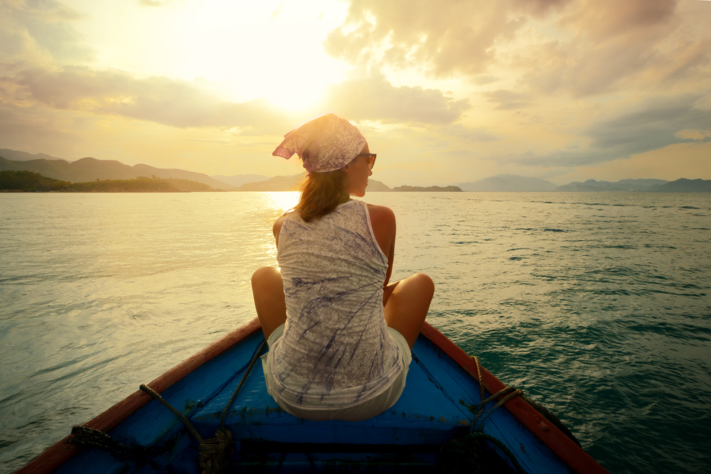 Woman,Traveling,By,Boat,At,Sunset,Among,The,Islands.