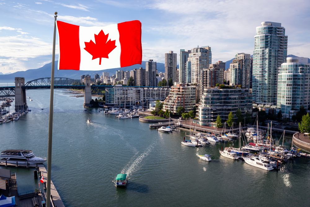 National,Canadian,Flag,With,Modern,Downtown,City,In,Background,During
