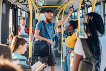 Diverse,Man,And,Woman,Couple,Passengers,Talking,While,Riding,In