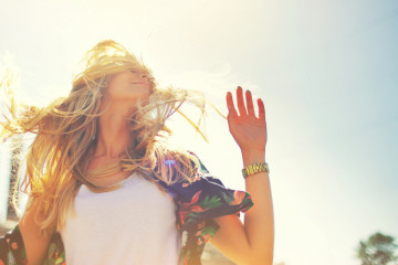 Attractive,Happy,Young,Woman,In,White,T,Shirt,Flying,Hair