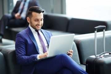 Elegant,Young,Man,With,Laptop,Looking,At,Its,Display,With