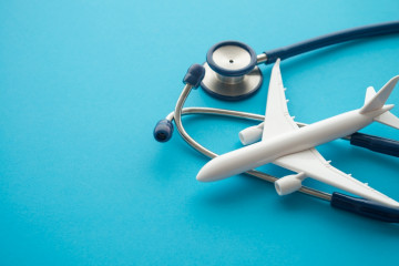 Airplane,And,Stethoscope,On,Blue,Background,With,Copy,Space.,Going