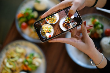 Top,View,Woman,Taking,Photo,Of,Food,With,Phone,In