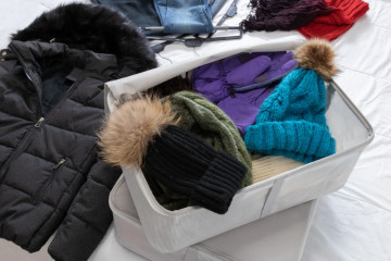 Horizontal,Photo,,Winter,Clothes,On,A,Bed,,Woolen,Hats,And