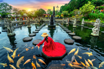 Woman,Feeding,Colorful,Fish,In,Pond,At,Tirta,Gangga,Water