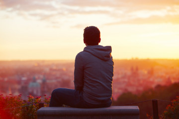 Young,Man,Is,Looking,At,The,Sunrise.