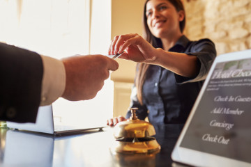 Guest,Takes,Room,Key,Card,At,Check-in,Desk,Of,Hotel,