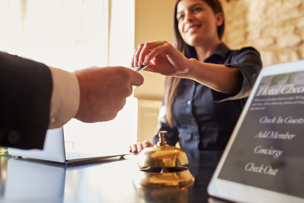 Guest,Takes,Room,Key,Card,At,Check-in,Desk,Of,Hotel,