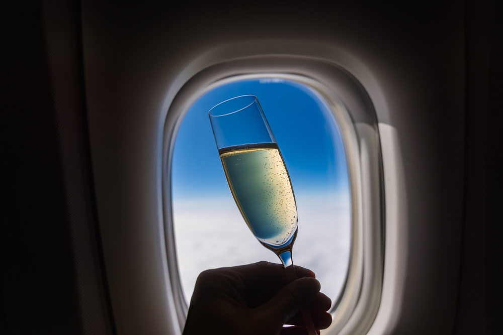 Champagne,Glass,With,Window,In,International,Flight
