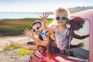 Portrait,Of,A,Smiling,Family,With,Two,Children,At,Beach