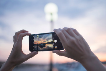 Woman,Using,Smart,Phone,Take,A,Photo,Sunset,View