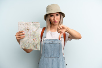 Blonde,Woman,Feeling,Cross,showing,Thumbs,Down.,Tourist,And,Map,Concept